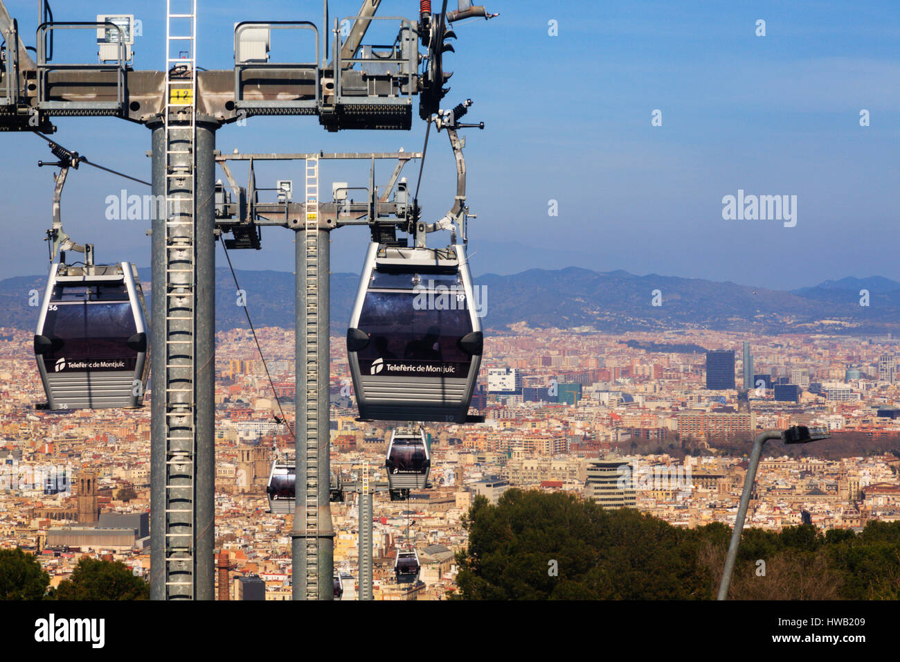 Cable cars of the Teleferic De Montjuic rise over Barcelona. Catalunya ...