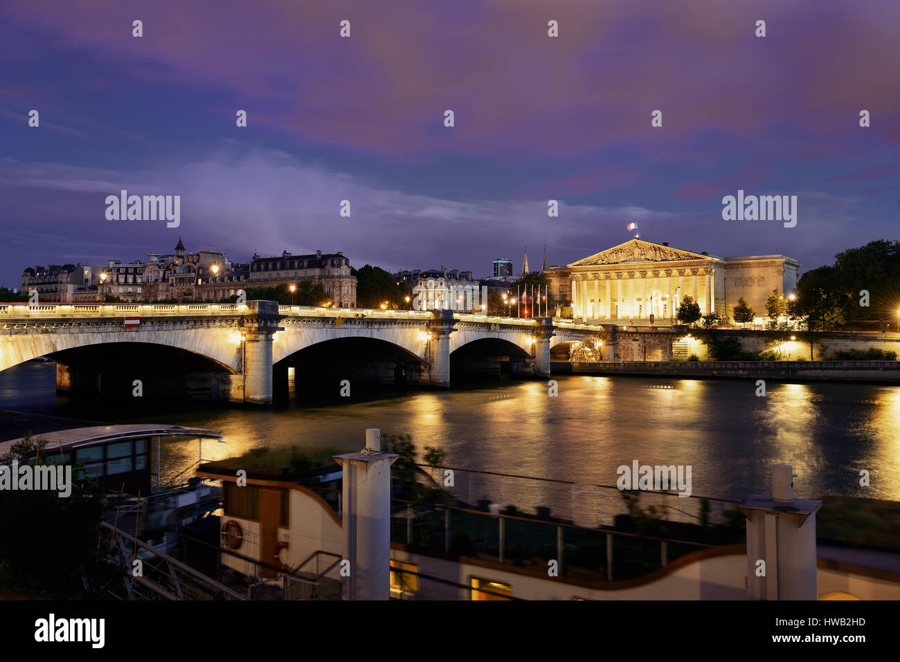 Paris River Seine with Pont de la Concorde and Assemblee Nationale at dusk Stock Photo