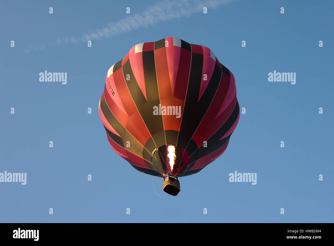 Balloon firing up against a blue sky Beaconsfield,Surrey. Stock Photo