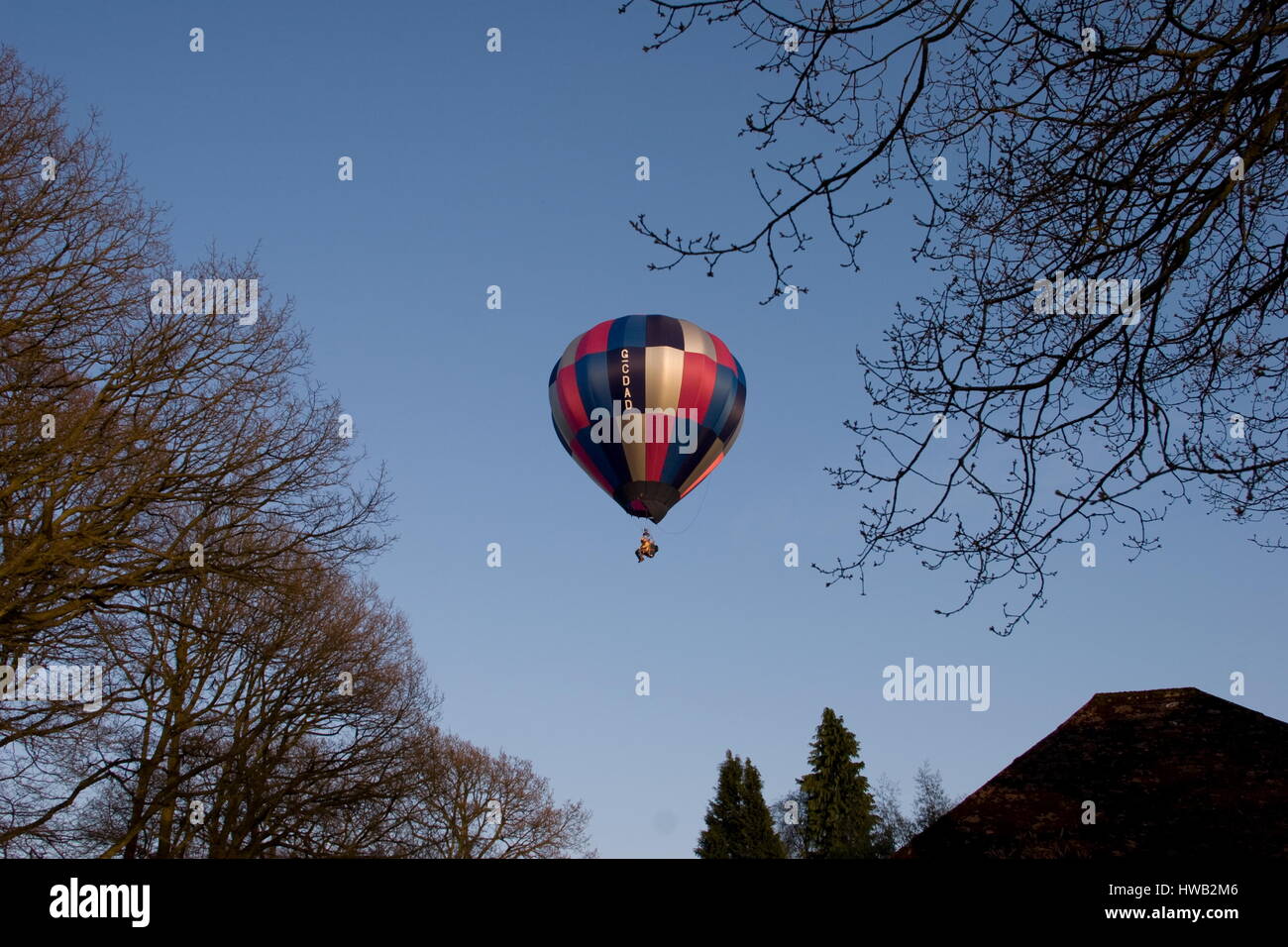 Balloon with a person in a chair flying,Beaconsfield,Surrey. Stock Photo