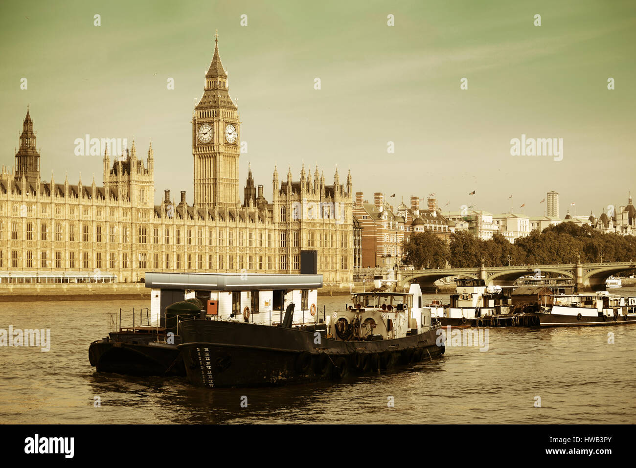 Big Ben and House of Parliament in London with boat in Thames River. Stock Photo