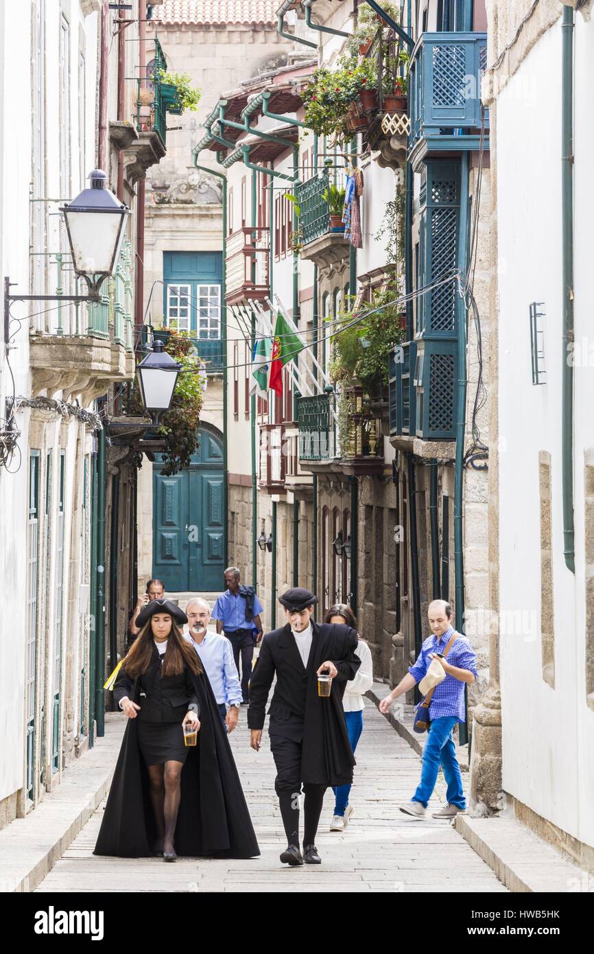Portugal, North region, Guimaraes, historical center listed as World Heritage by UNESCO, the oldest street Santa Maria of the city and students dressed with the traje academico during the party of Latada (festa da latada) of university of Minho Stock Photo