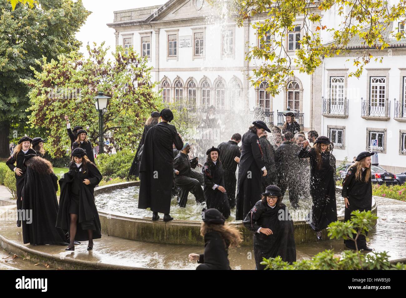 Portugal, North region, Guimaraes, historical center listed as World Heritage by UNESCO, party of Latada (festa da latada) of university of Minho, students dressed with the traje academico and the tricornio, Largo Martins Sarmento with a view of the house casa Onde Falleceu where died Francisco Martin Sarmento Stock Photo