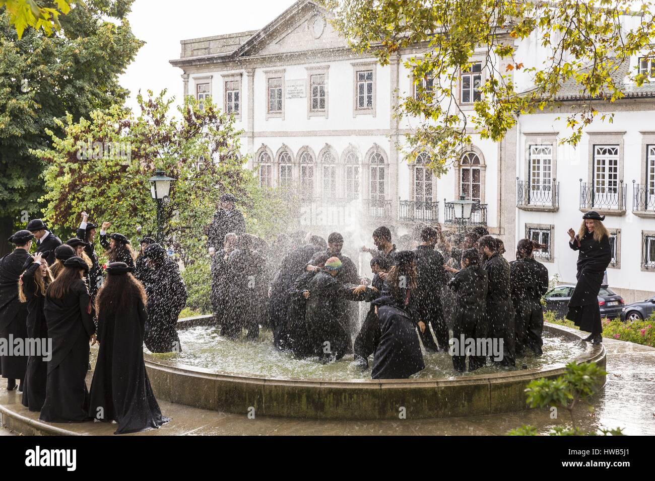 Portugal, North region, Guimaraes, historical center listed as World Heritage by UNESCO, party of Latada (festa da latada) of university of Minho, students dressed with the traje academico and the tricornio, Largo Martins Sarmento with a view of the house casa Onde Falleceu where died Francisco Martin Sarmento Stock Photo