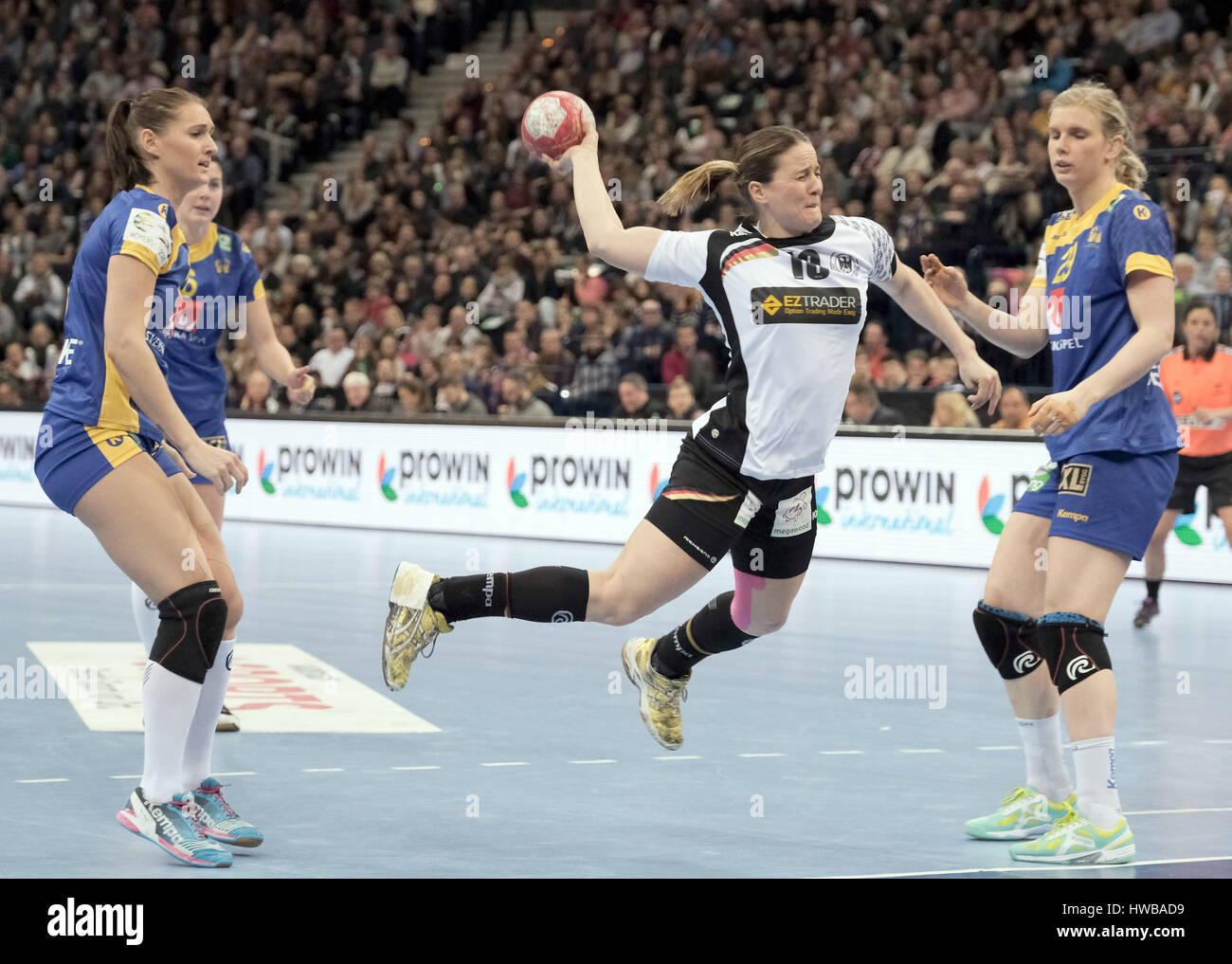 Hamburg, Germany. 19th Mar, 2017. Germany's Anna Loerper (M) scores against Sweden's Marie Wall (L) and Jenny Alm during the women's handball match between Germany and Sweden at the Barclaycard Arena in Hamburg, Germany, 19 March 2017. The match ended 23-24. Photo: Axel Heimken/dpa/Alamy Live News Stock Photo