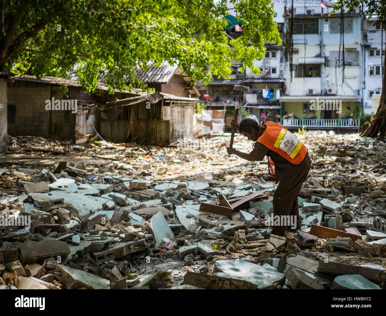Bangkok, Bangkok, Thailand. 20th Mar, 2017. A city worker uses a sledge hammer to break up the floor of what used to be a home in Pom Mahakan. The family who lived there was evicted and the home torn down. The final evictions of the remaining families in Pom Mahakan, a slum community in a 19th century fort in Bangkok, have started. City officials are moving the residents out of the fort. NGOs and historic preservation organizations protested the city's action but city officials did not relent and started evicting the remaining families in early March. (Credit Image: © Jack Kurtz via ZUMA Wir Stock Photo