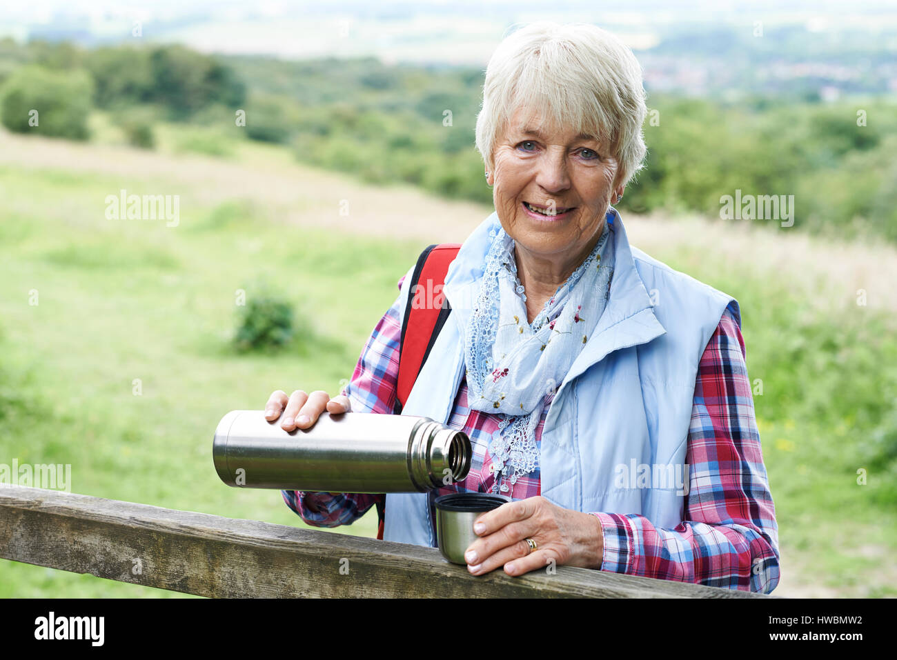 Senior Man On Hike Having Hot Drink Stock Photo