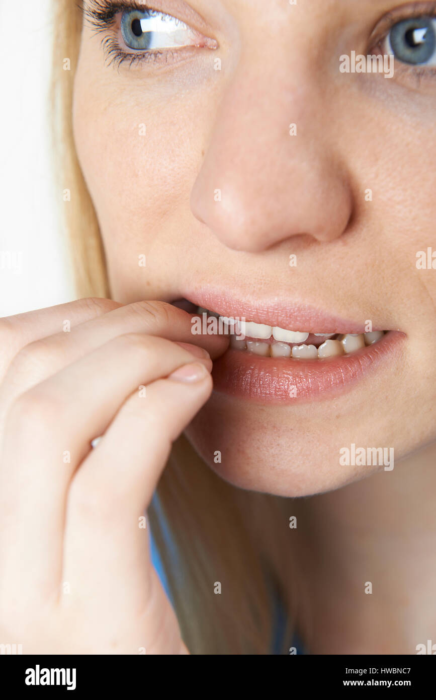 Close Up Of Nervous Woman Biting Nails Stock Photo