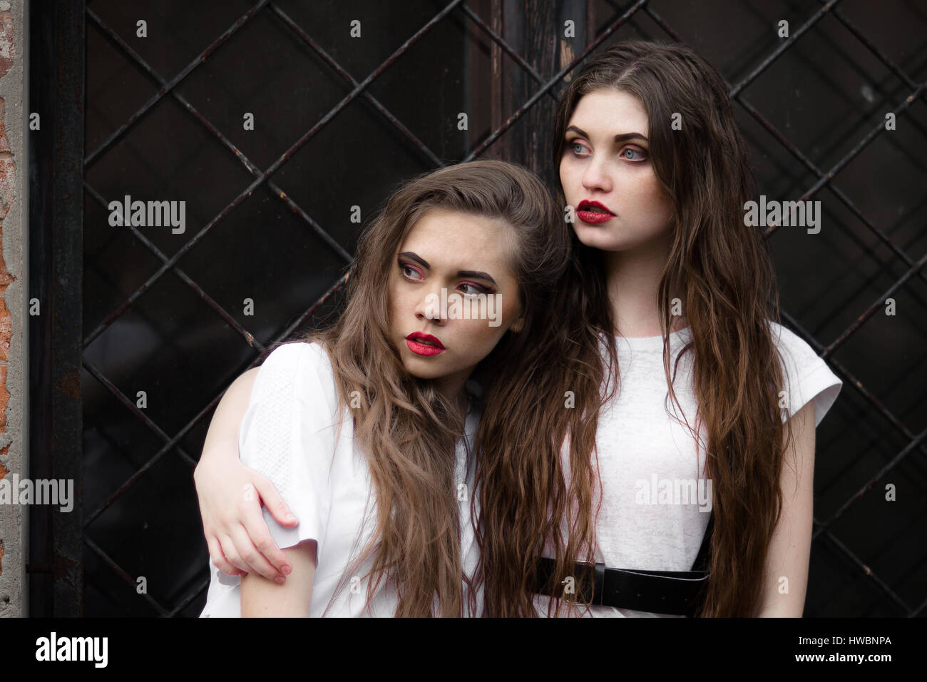 Two beautiful nurces in white coat looking aside Stock Photo