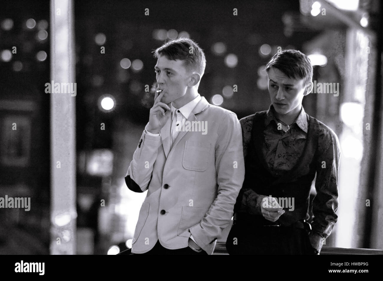 Detectives on the night city streets. Local strong serious mafia, mafia group. Young men in expensive luxuty suits, hat open, begin new business. Two  Stock Photo