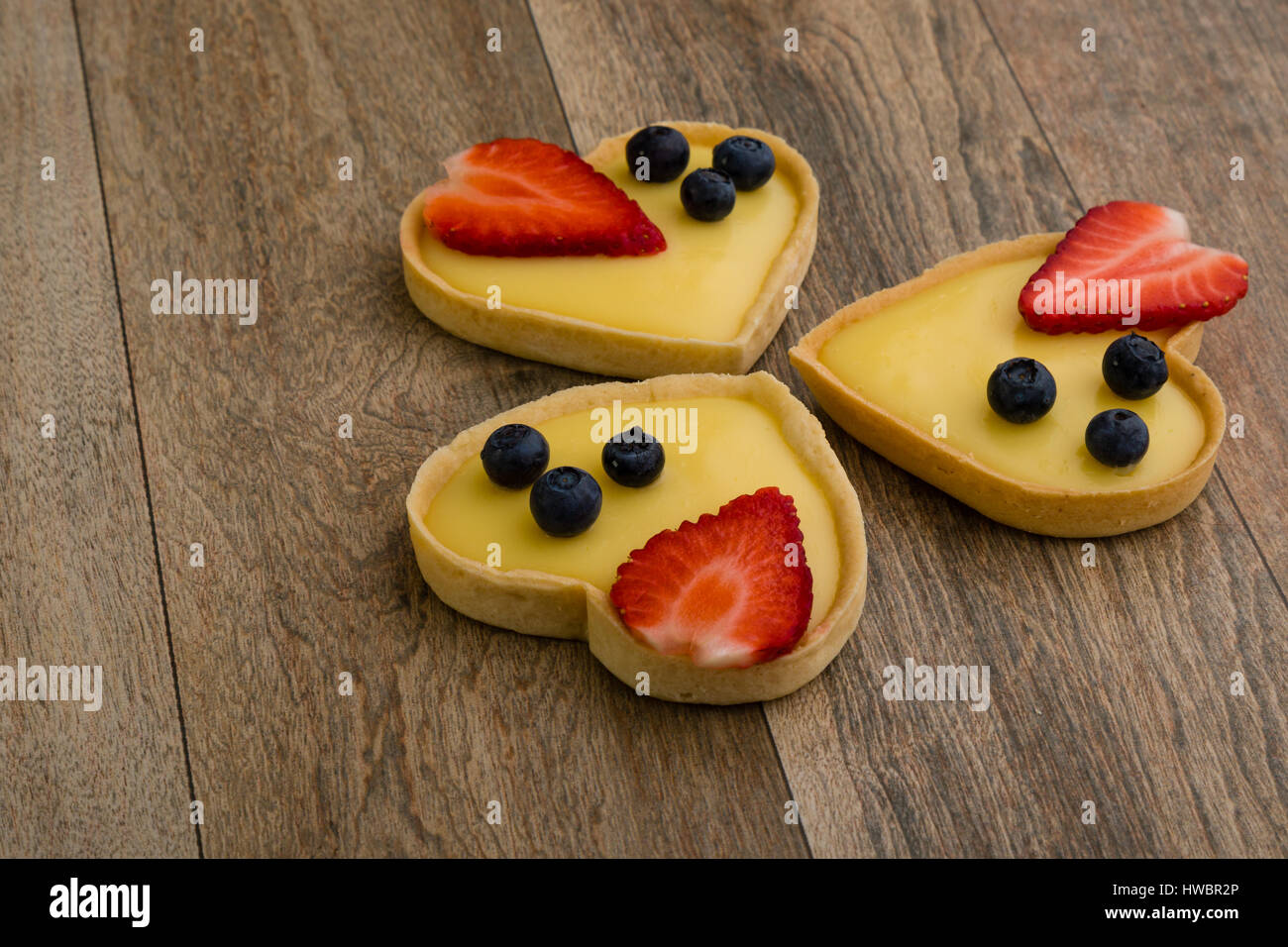 heart shape vanilla tart with strawberry and blueberry Stock Photo