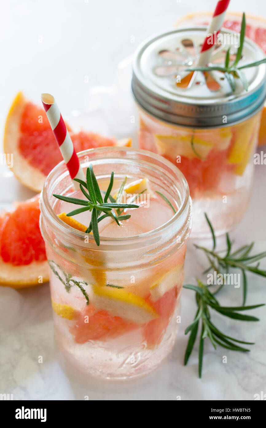 Refreshing summer drink with grapefruit and rosemary on a stone ...