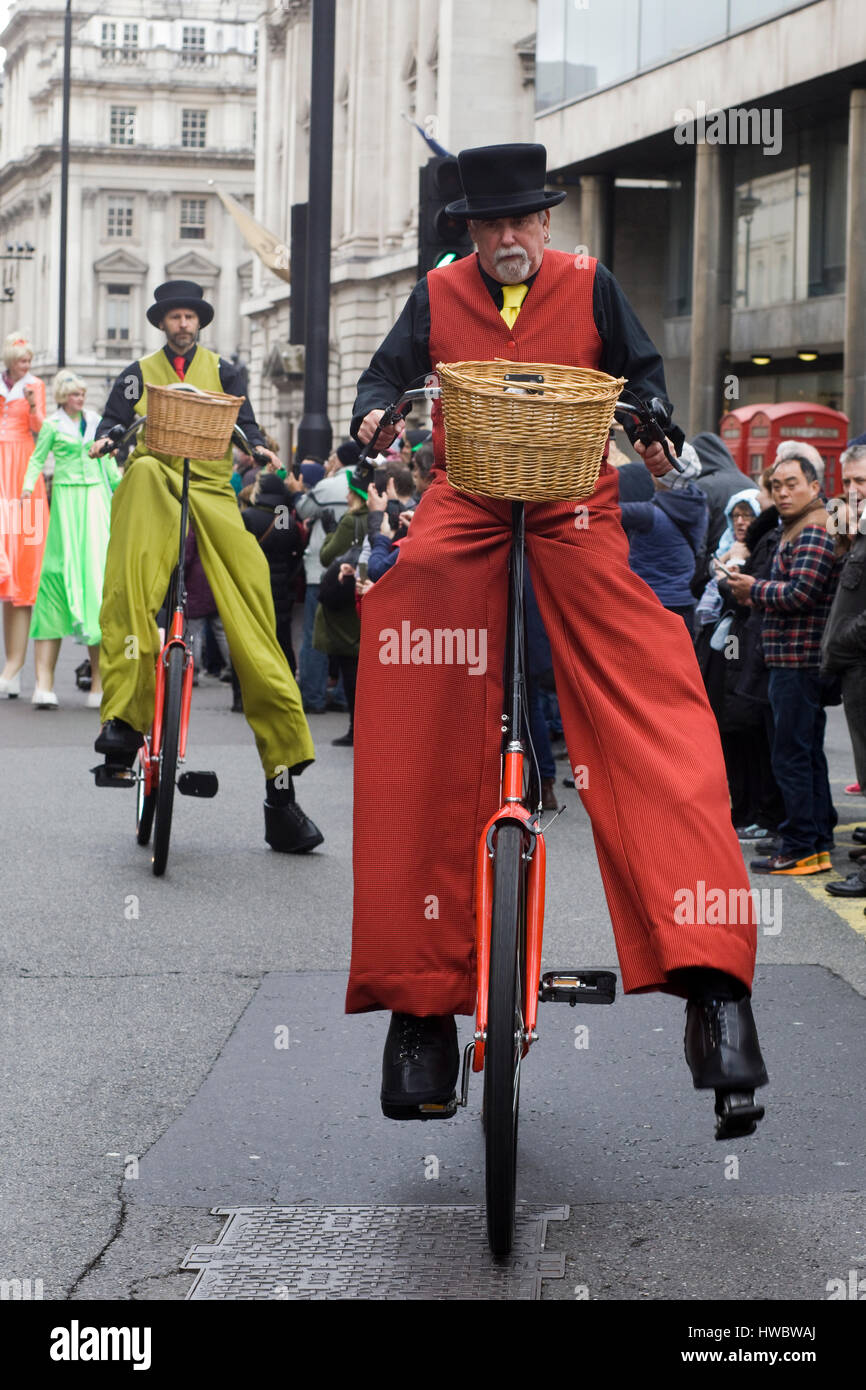 man on a giant bicycle wearing stilts Stock Photo Alamy