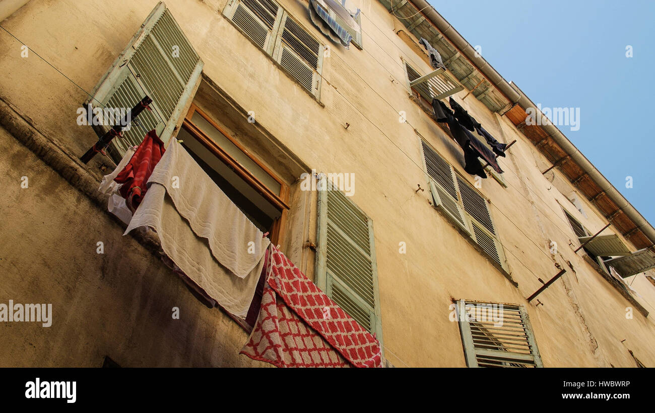 Exterior of buildings in Europe with clothes hanging from window Stock Photo