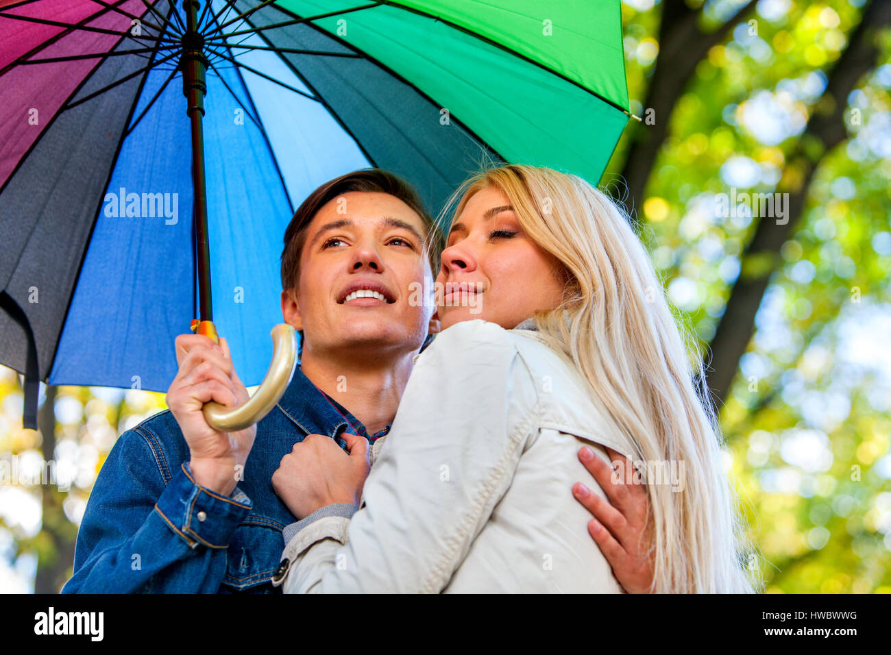 Autumn couple walking park. Fall friends walk under rain umbrella Stock ...