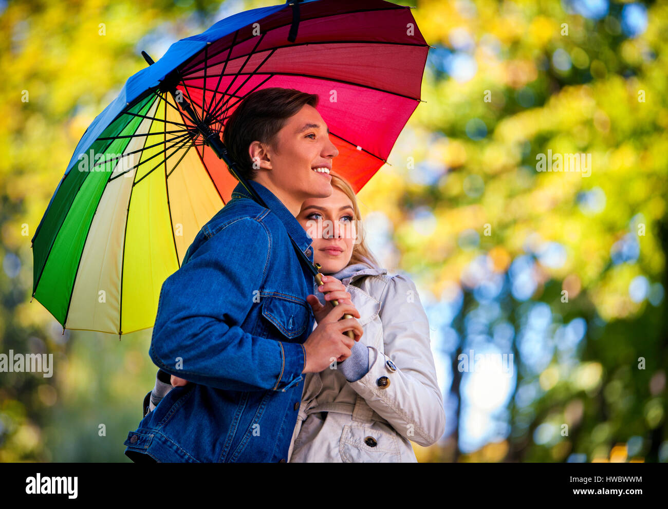 Autumn couple walking park. Fall friends walk under rain umbrella Stock ...