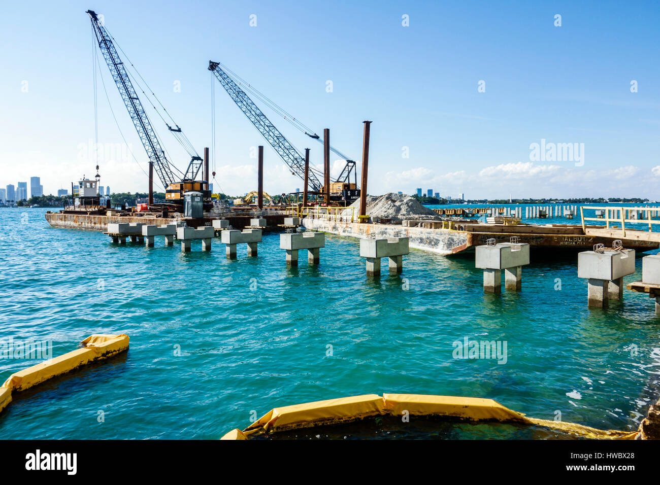 Miami Beach Florida,Biscayne Bay,water,dock,pier,concrete pilings,foundation,construction site,barge,crane,water,FL170205040 Stock Photo