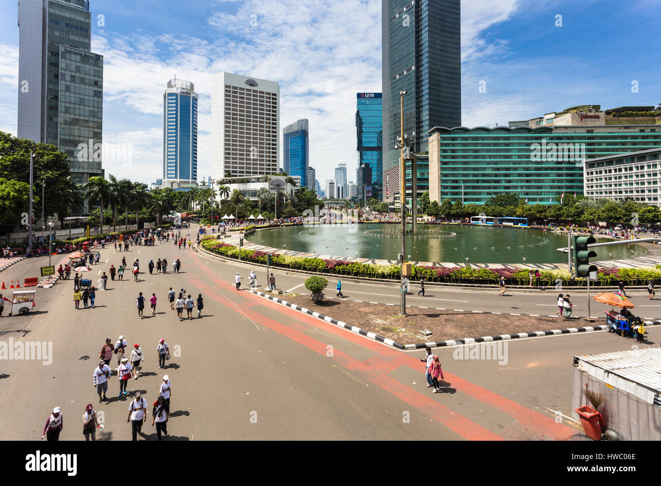 JAKARTA, INDONESIA - SEPTEMBER 25, 2016: People enjoy the car free day, which happens every Sunday morning, on the Sudirman avenue in the heart of Ind Stock Photo
