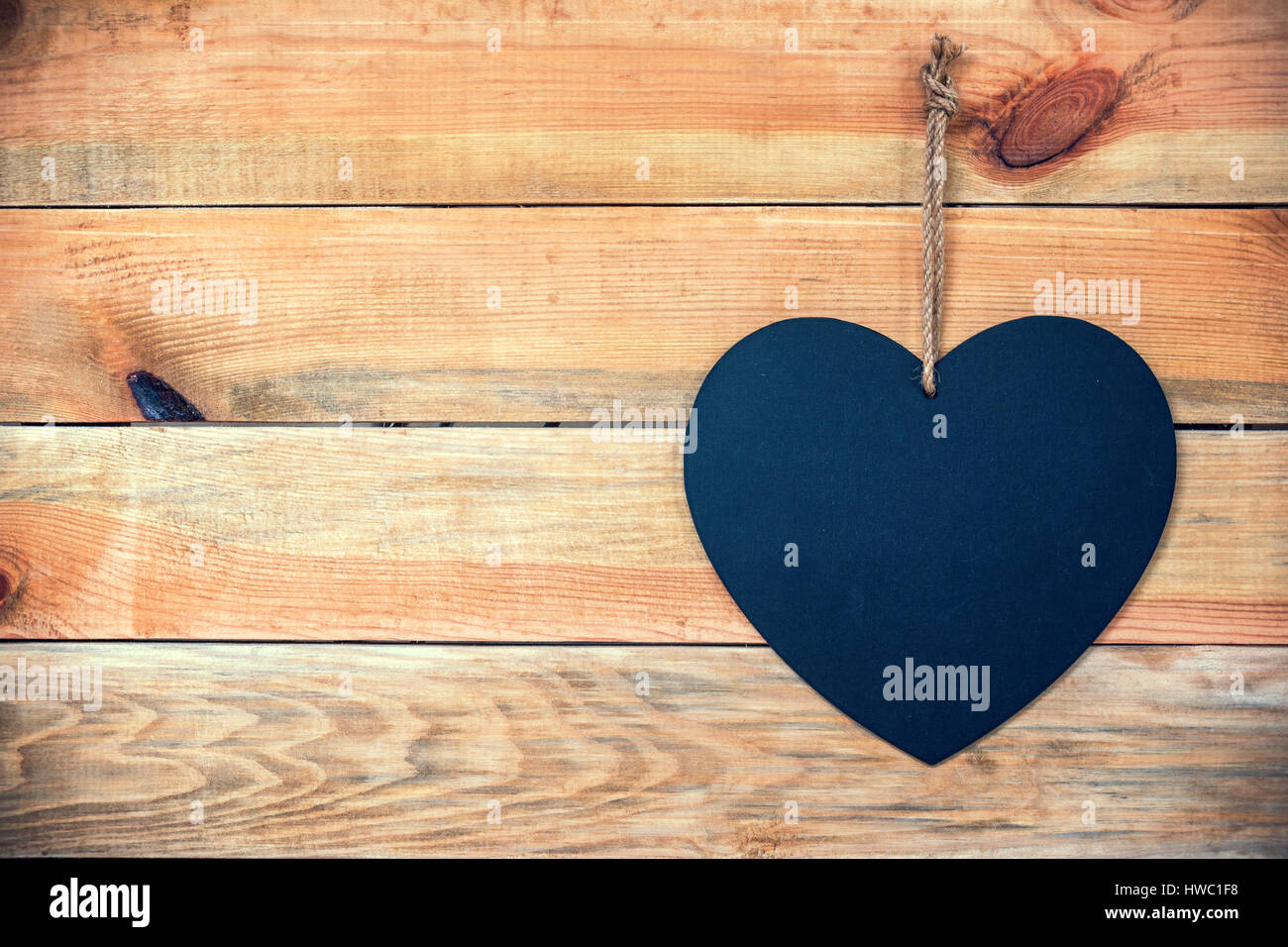 Wood planks with a chalkboard in the shape of a  heart, love greeting card background with copy space for text Stock Photo