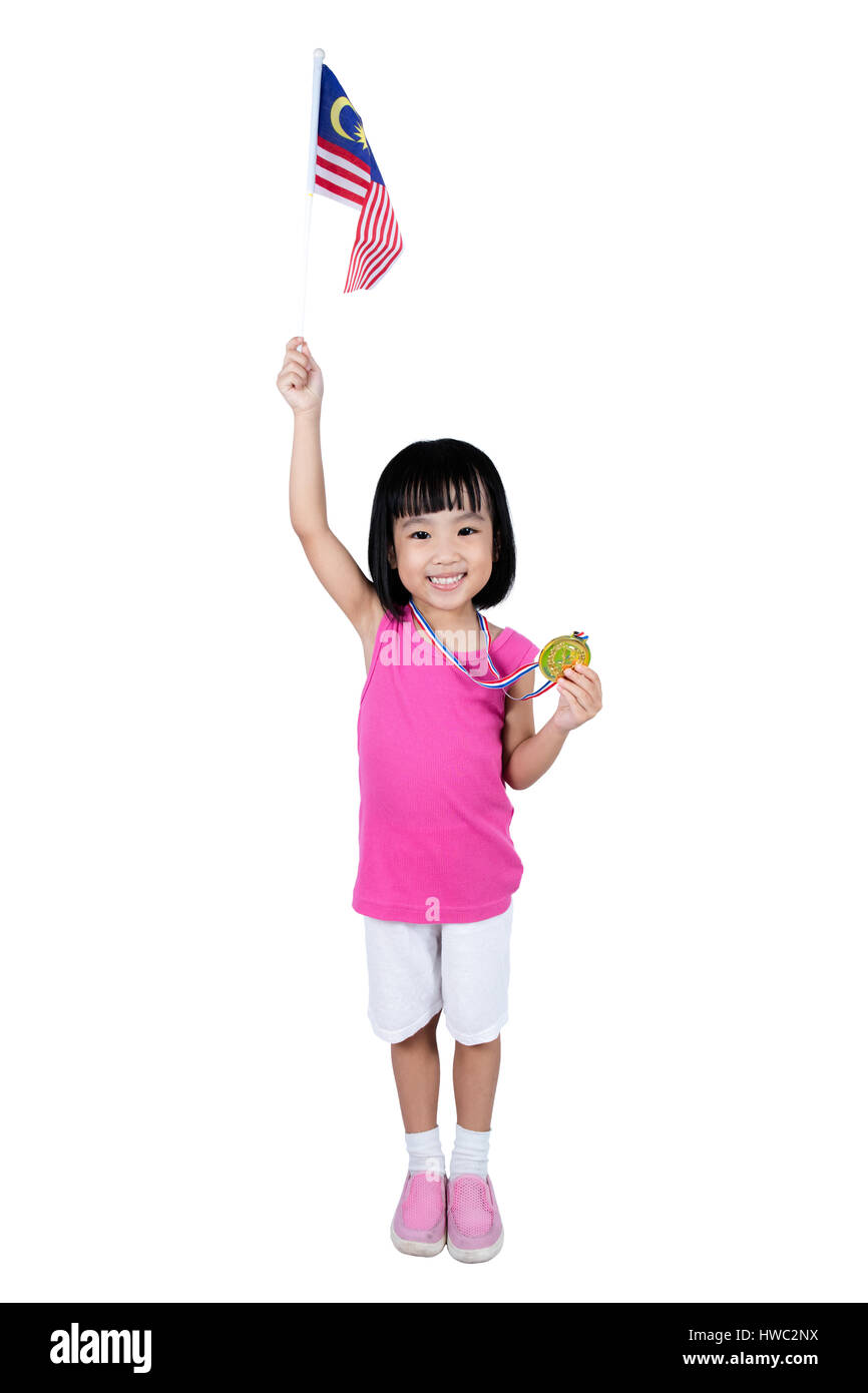 Asian Chinese little girl holding Malaysia Flag with gold medal in isolated plain white background. Stock Photo