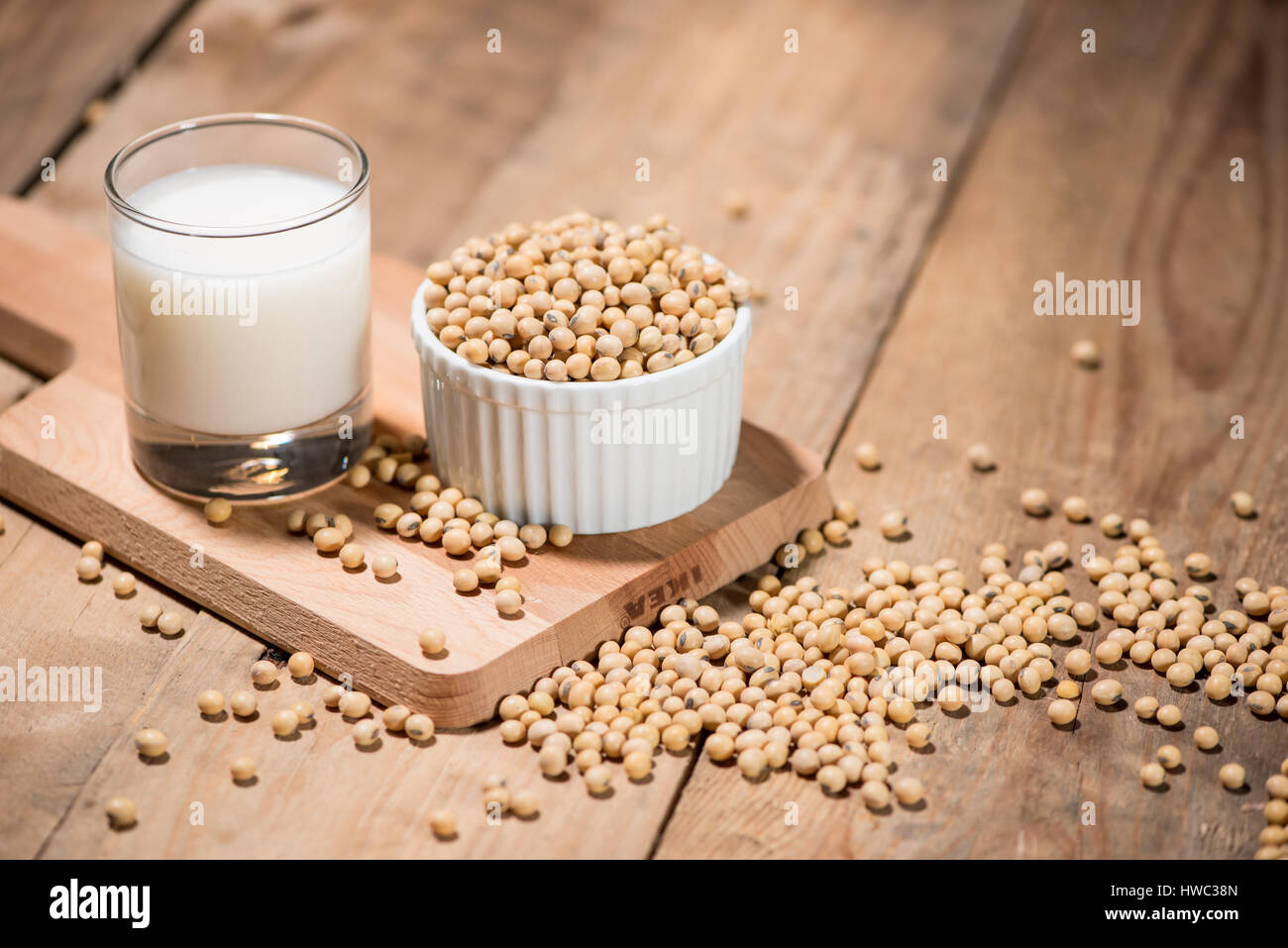 Soy milk or soya milk and soy beans on wooden table. Stock Photo