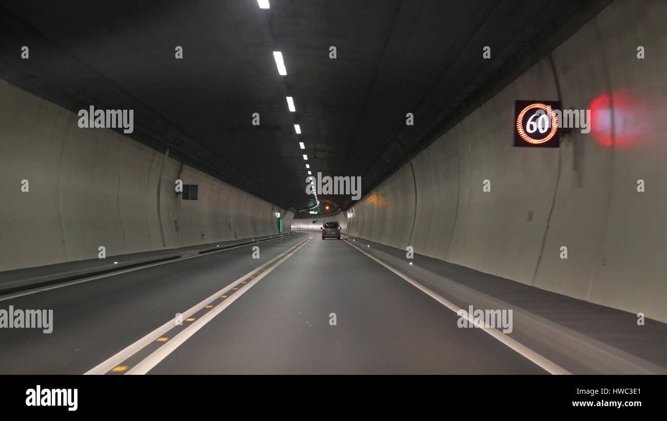 Light and projected shadows inside the Vedeggio-Cassarate road tunnel with lights,signs and traffic Stock Photo