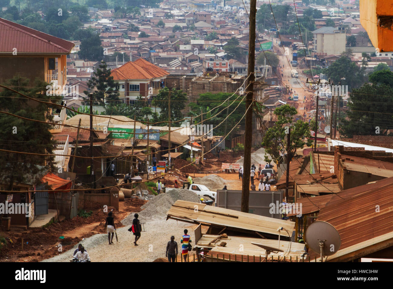 An overlook of Makerere, one of the northern parishes of Kampala city. In Luganda, the original local language of the Kampala region, Kampala means the city on seven hills. But as an effect of the huge population growth, many people are forced to live in the wetlands between the hills. Many of the wetland-areas are slums, but this one is just a regular area of Kampala. Stock Photo