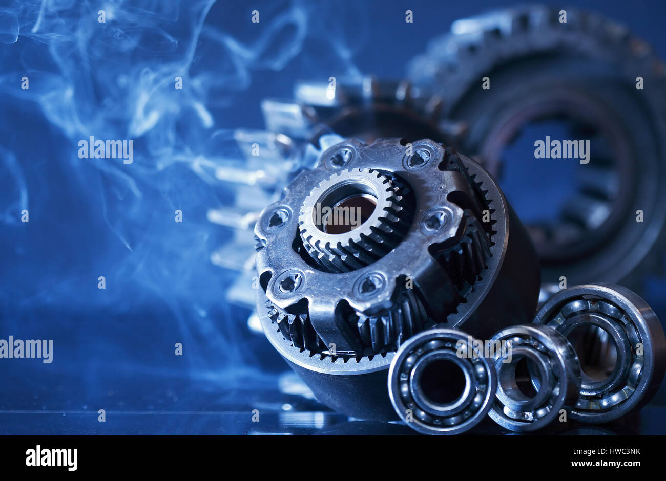 Machinery concept. Set of various gears in smoke on dark background Stock Photo
