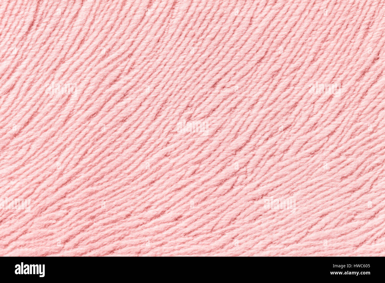 Light pink background from a soft wool textile material closeup. Fabric with natural texture. Stock Photo