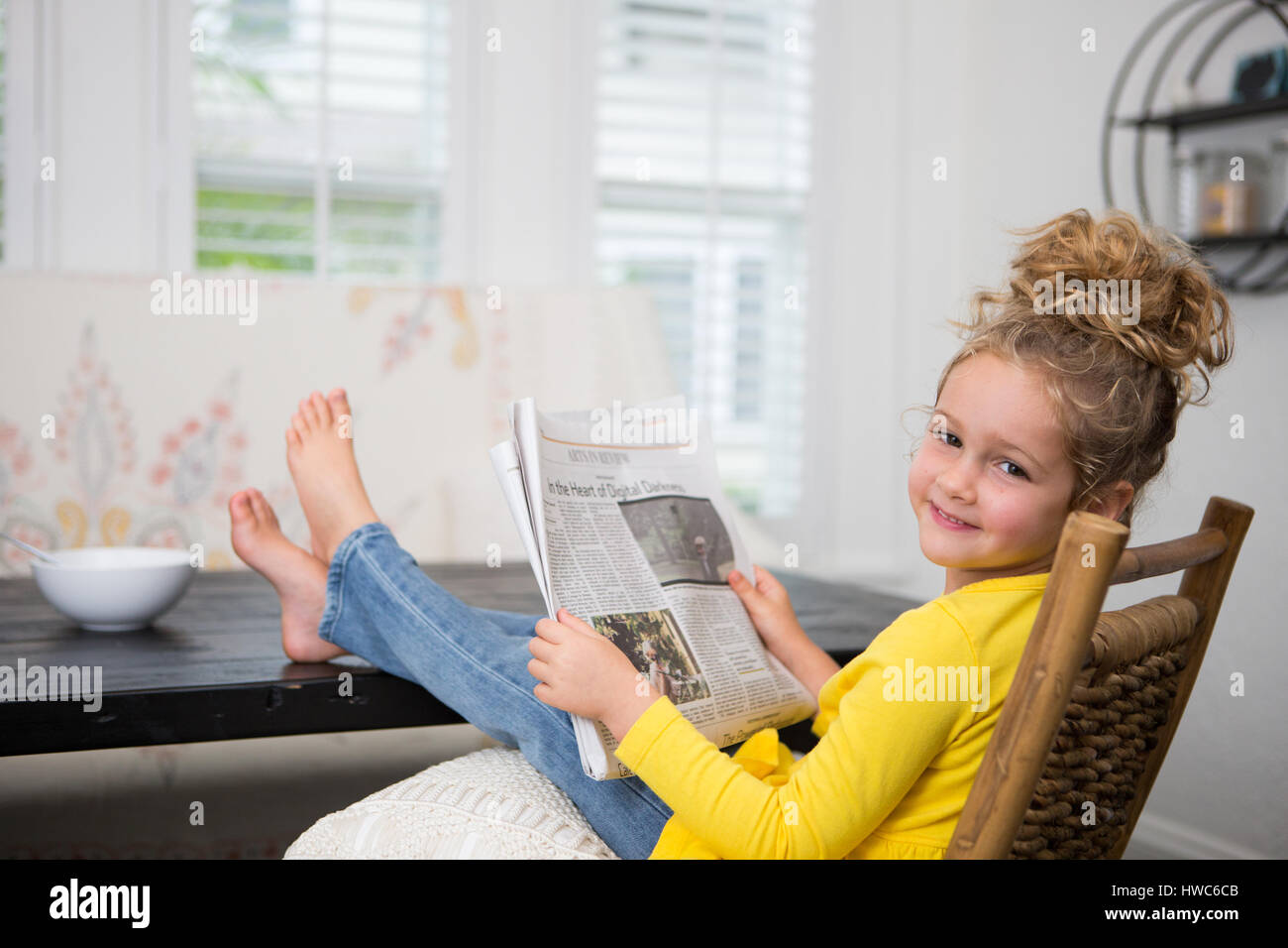 girl reading newspaper Stock Photo