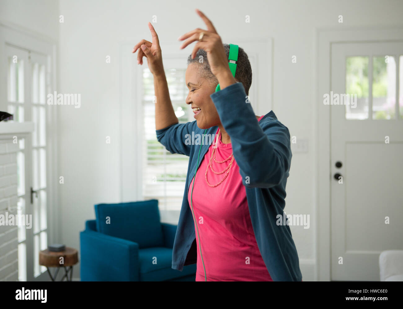 Senior woman listening to music on headphones Stock Photo