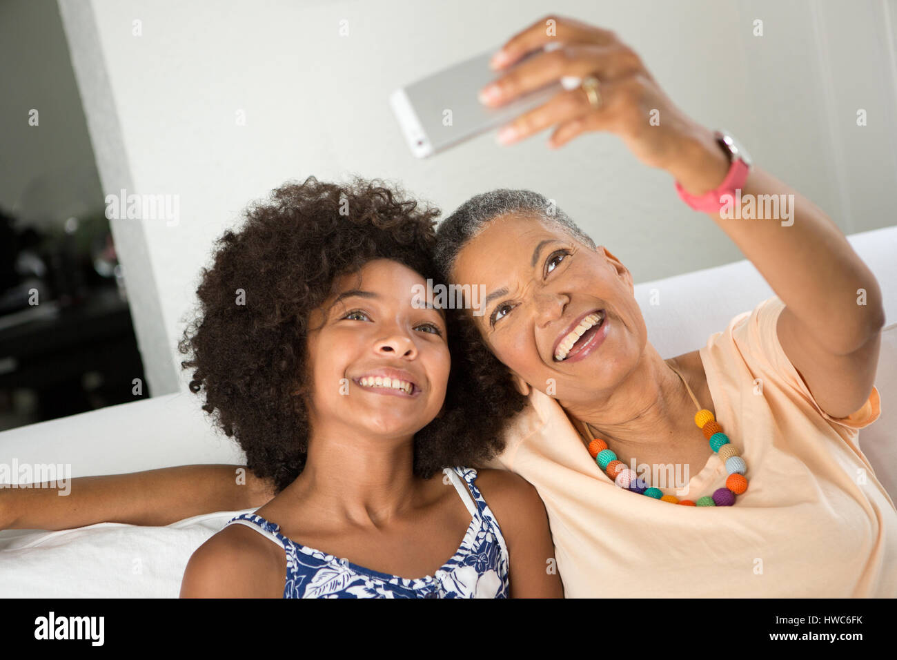 Girl teaching grandmother how to take a selfie Stock Photo