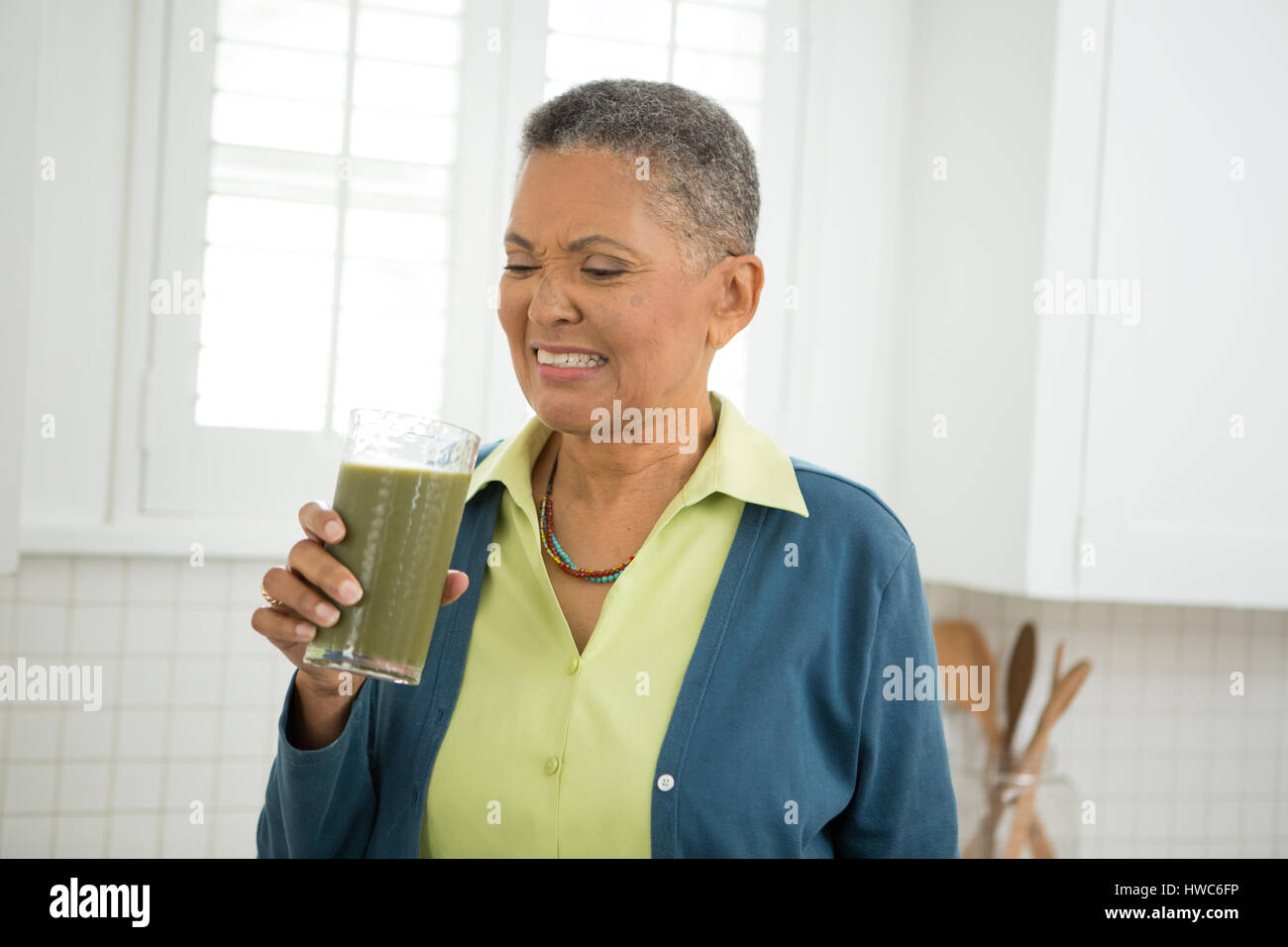 Senior woman drinks healthy smoothie Stock Photo