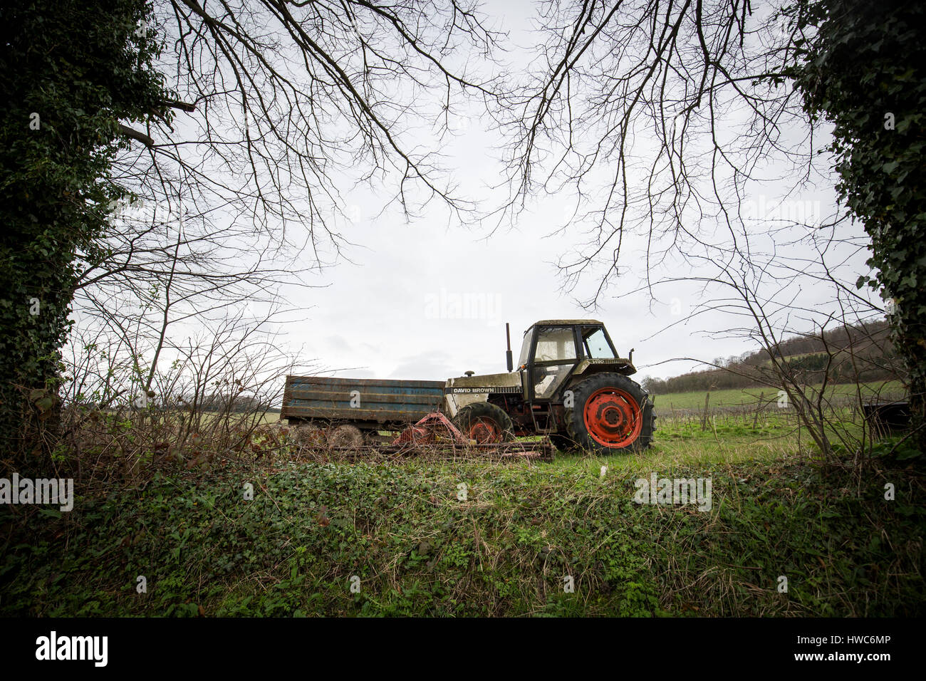 An old tractor in a field in Surrey , UK Stock Photo