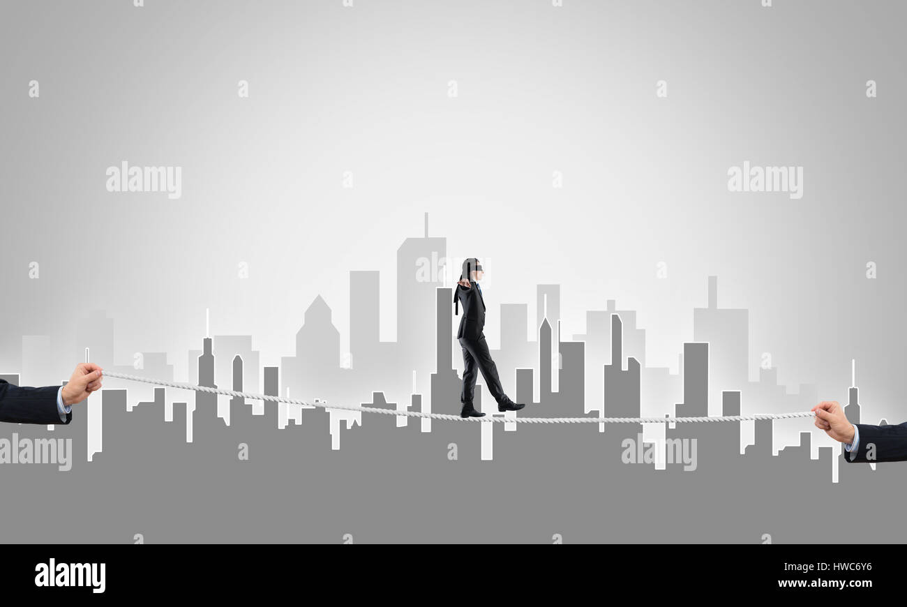 Business concept of risk support and assistance with man balancing on ...