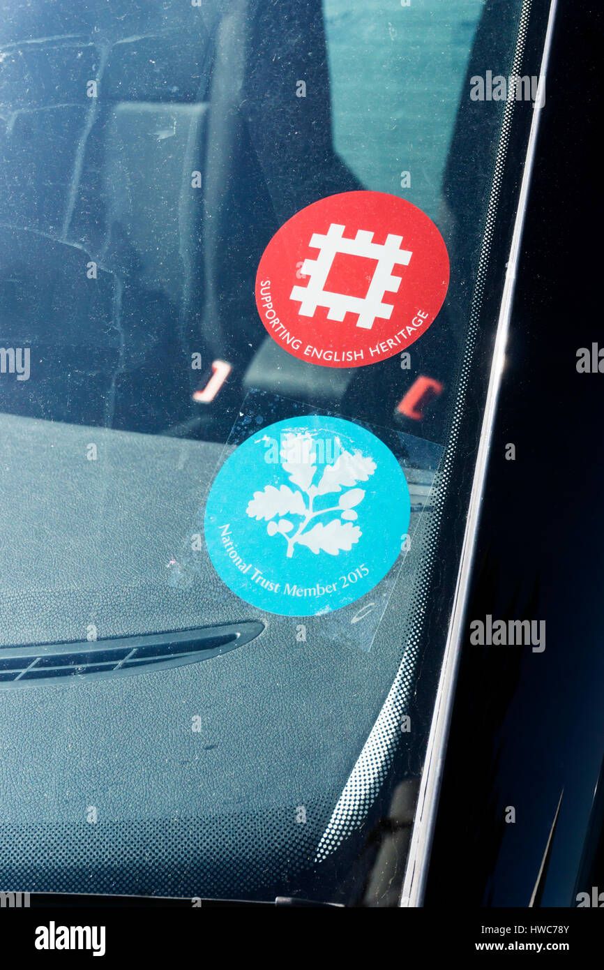 English Heritage and National Trust membership or subscription badges on a car windscreen. Stock Photo