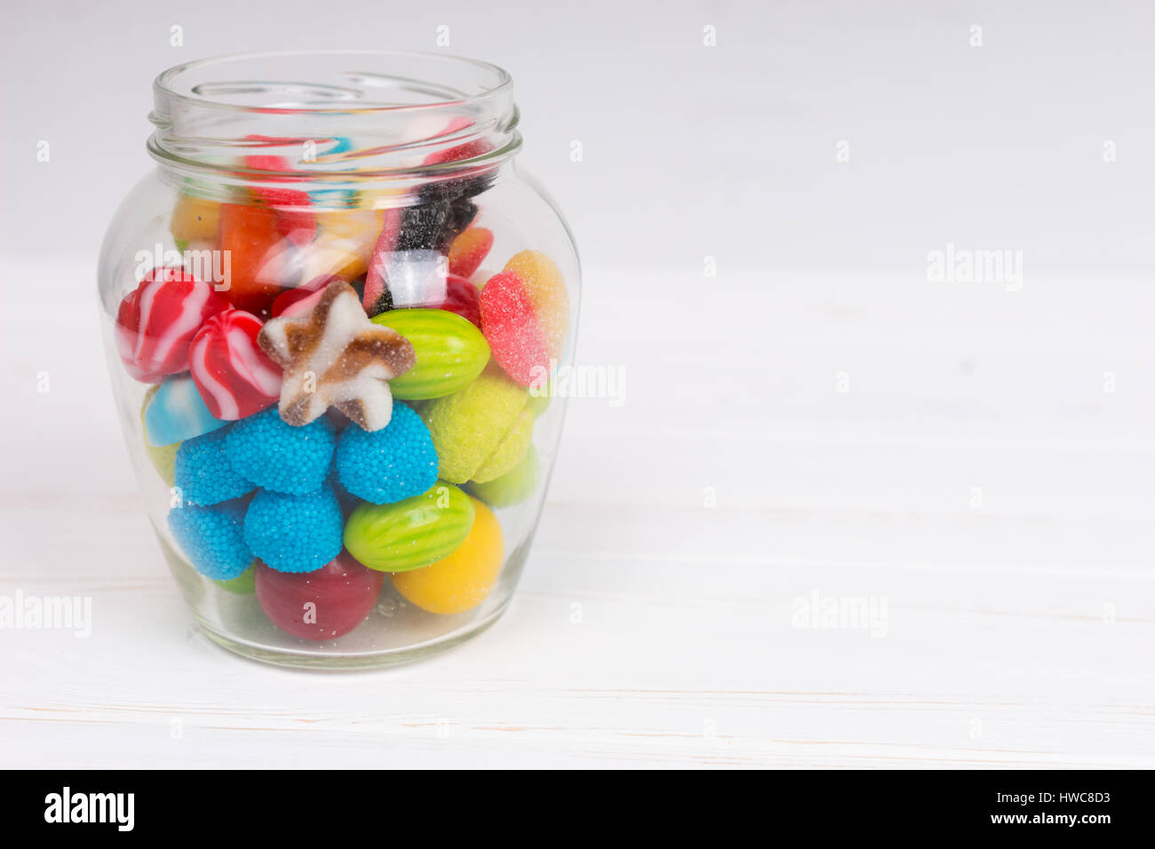 Chewing Sweets Tasty bright chewing sweets and jelly candies in the glass can on ...