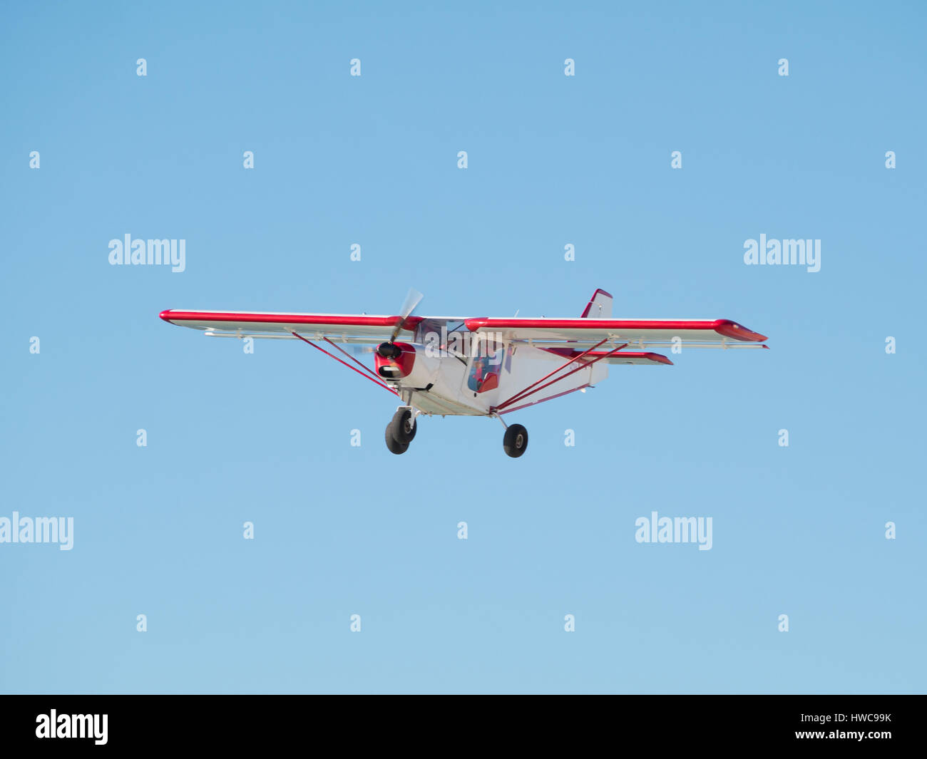Small airplane in a blue sky Stock Photo