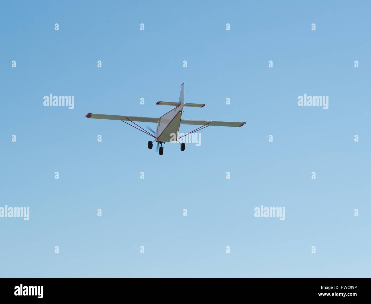 Small airplane in a blue sky Stock Photo