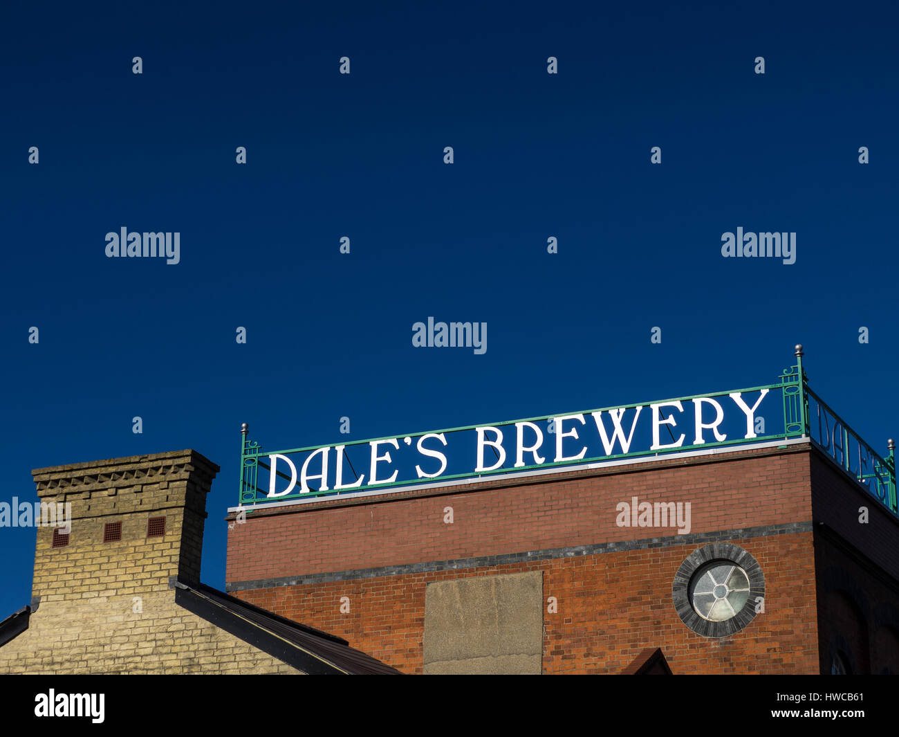 Rooftop signage on the old Dale's Brewery building in Cambridge's Mill Road area, now hosting antique shops and a cafe at the street level Stock Photo