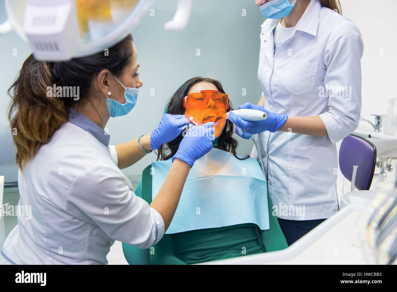 Dentist using curing light Stock Photo Alamy