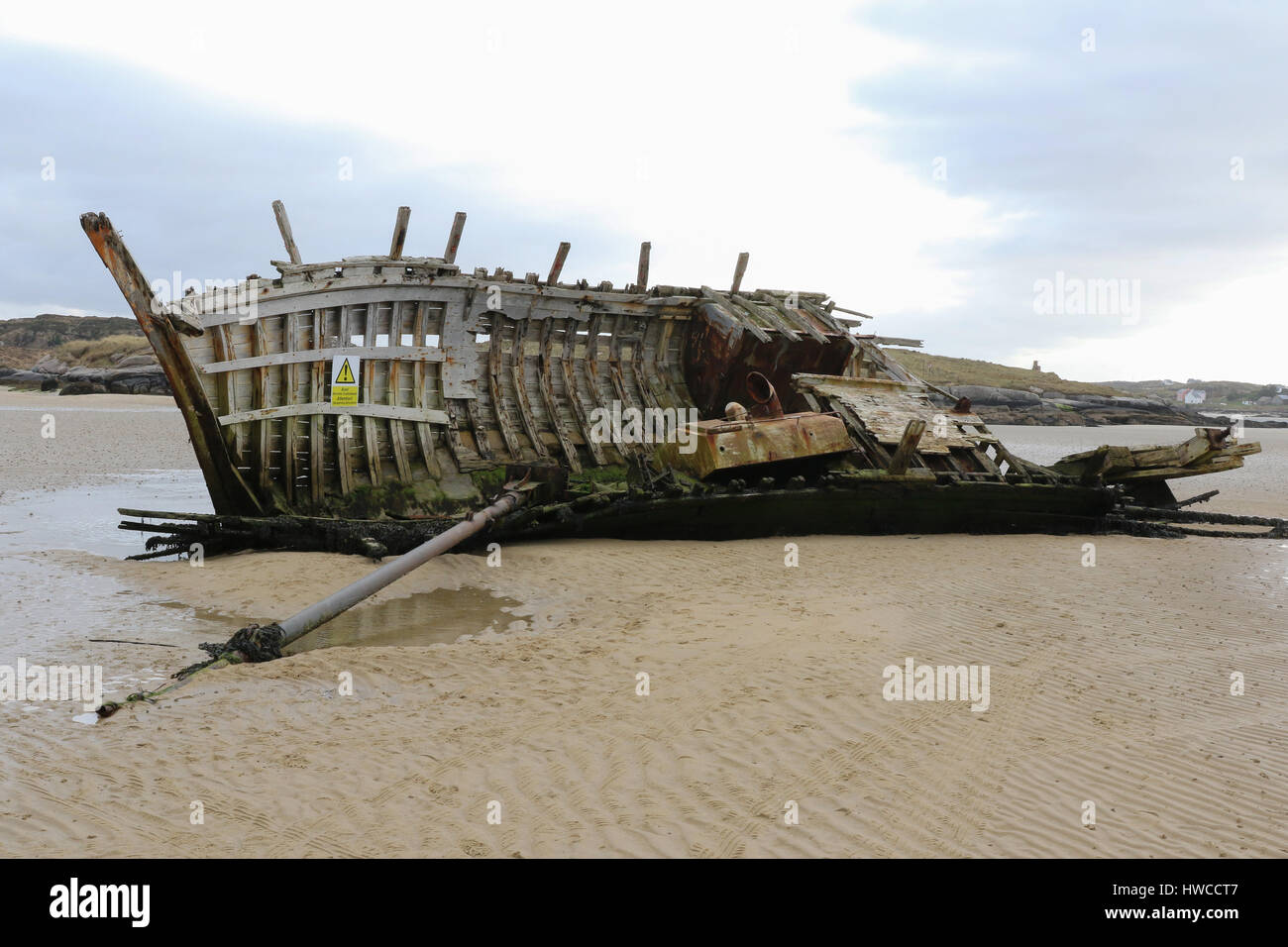 The wreck of a wooden fishing boat at Bunbeg, County Donegal, Ireland. The wreck is known as Bad Eddie's (fishing boat). Stock Photo