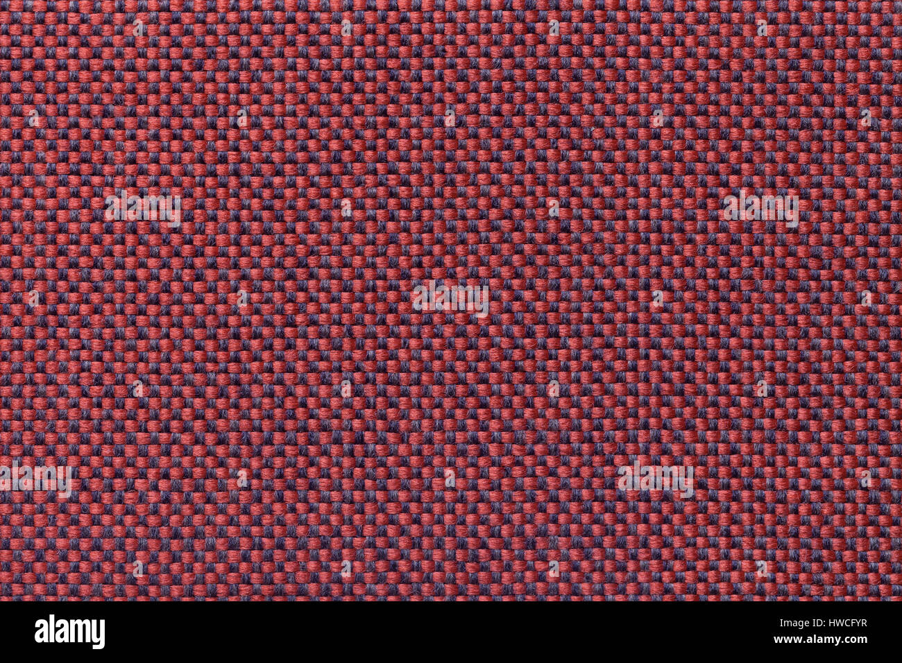 Dark red background with checkered pattern, closeup. Structure of the ...