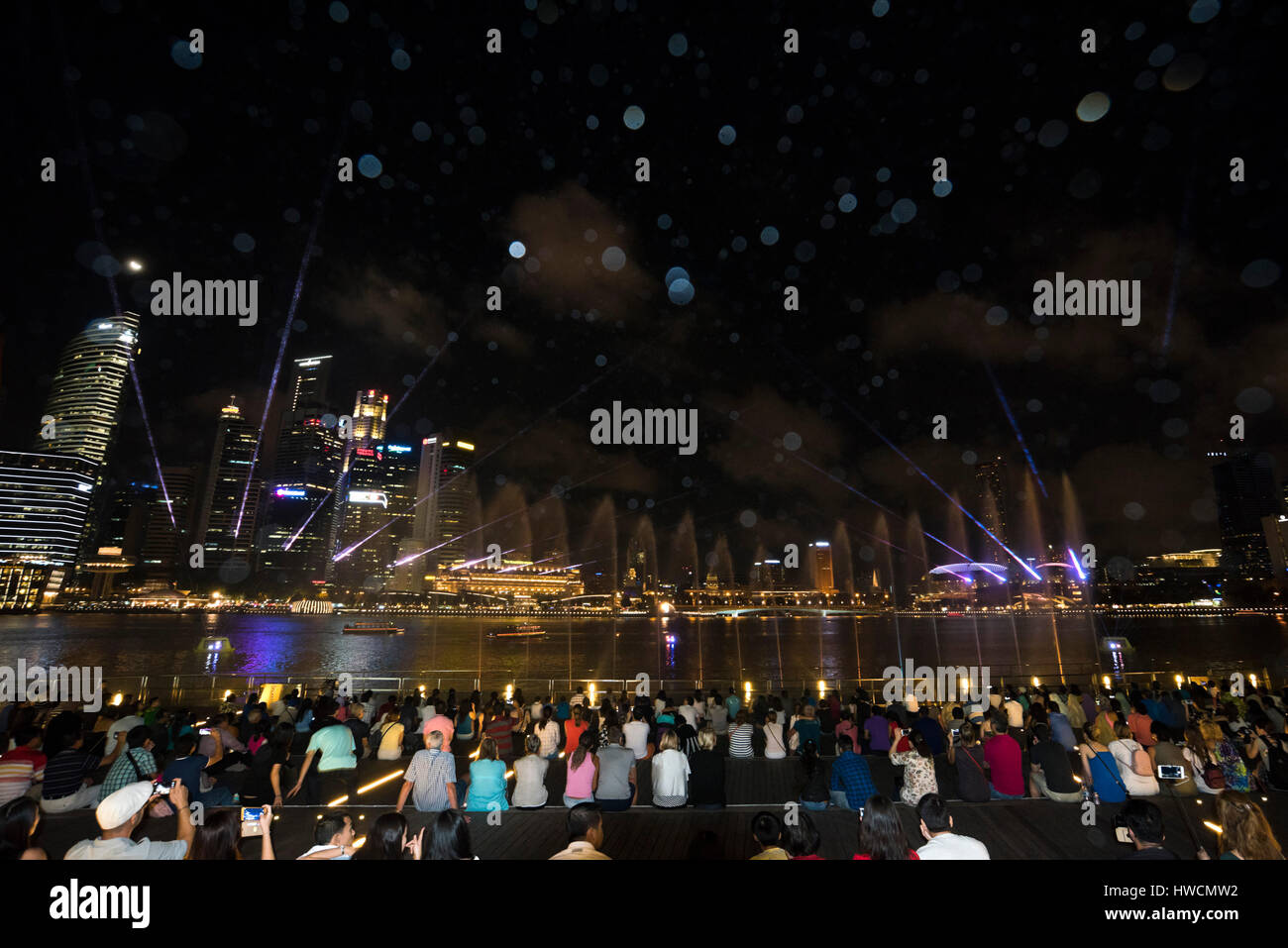 Horizontal view of the audience watching the Wonder Full light and sound show at night in Singapore. Stock Photo