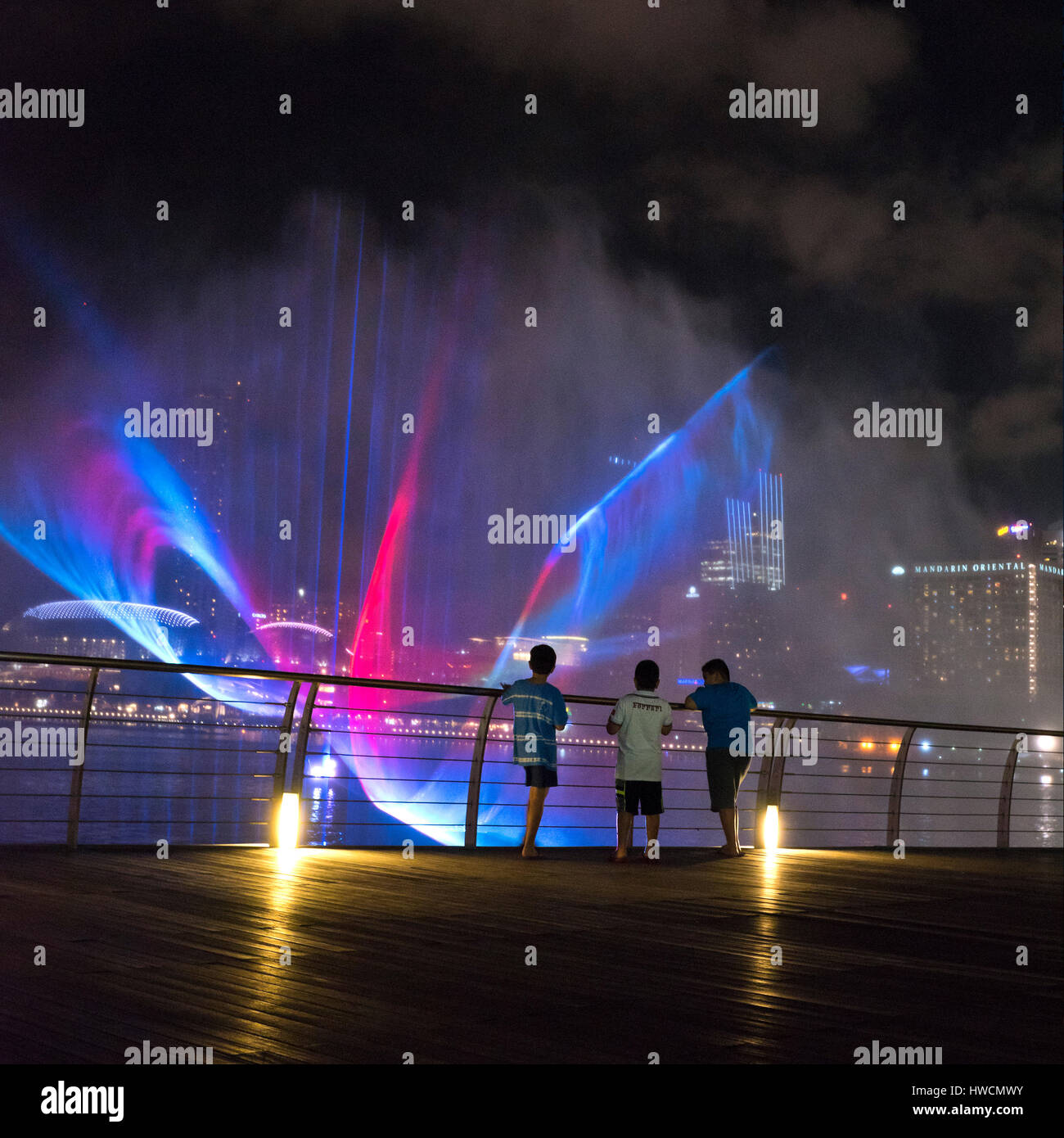 Square view of boys enjoying the Wonder Full light and sound show at night in Singapore. Stock Photo