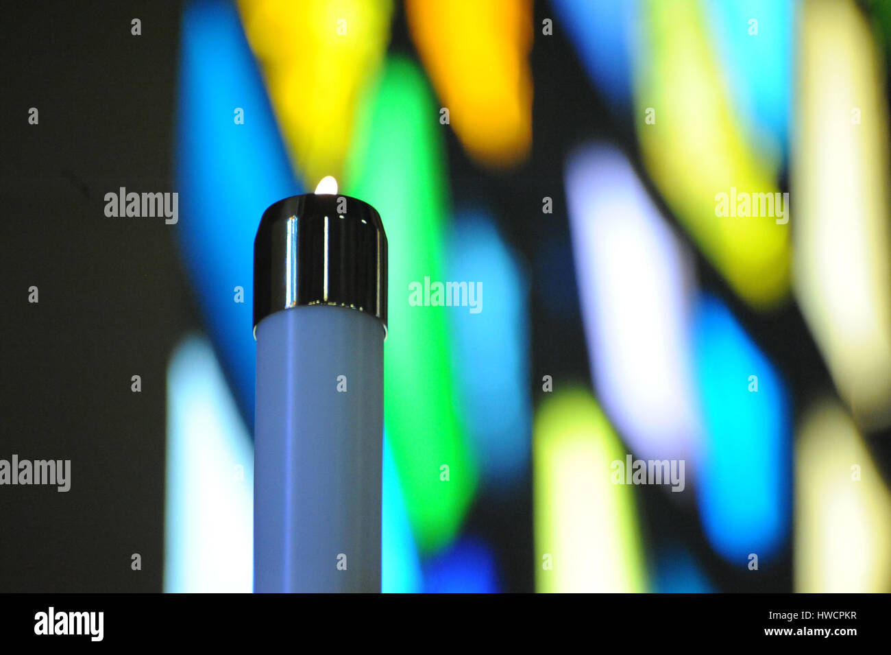 Lit Candle in Front of a Stained Glass Window Stock Photo Alamy