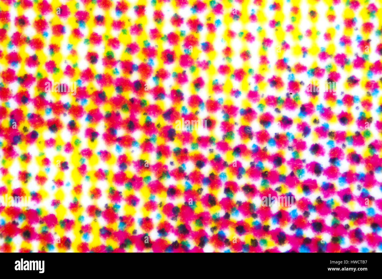 Four color printing on white paper under the microscope. CMYK Cyan Magenta Yellow and Key or black color process. Subtractive color mixing. Stock Photo