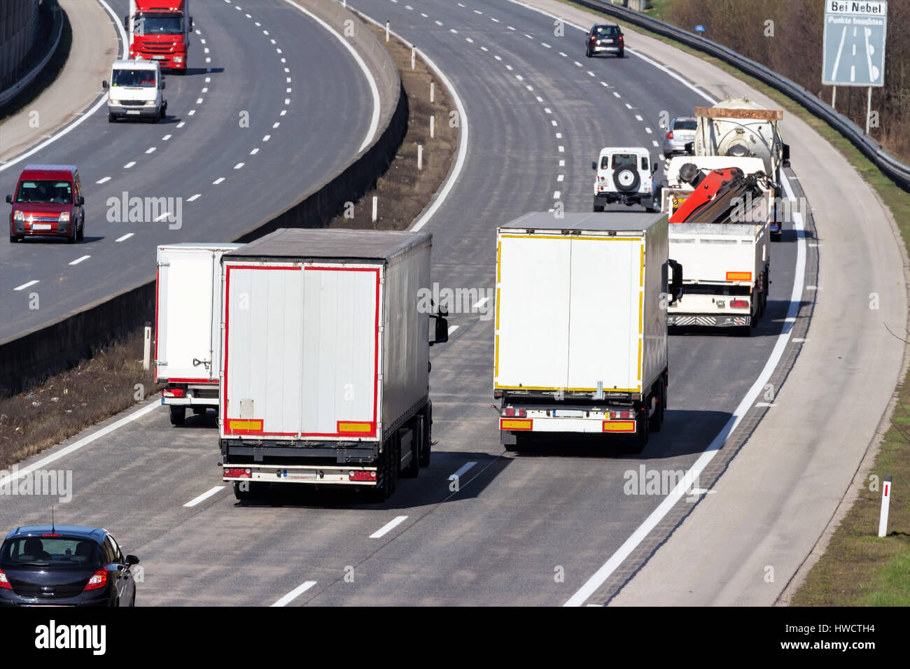 Trucks on the highway. Transport on the street for goods., Lastwagen auf der Autobahn. Transport auf der Straße für Güter. Stock Photo