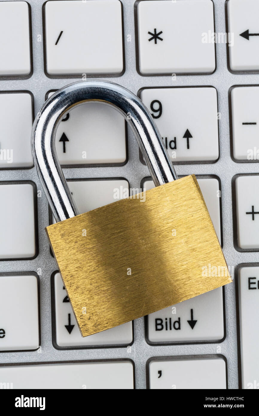 A padlock on a computer keyboard. Symbolic photo for data security and Hacking, Ein Vorhängeschloss auf einer Computer Tastatur. Symbolfoto für Datens Stock Photo