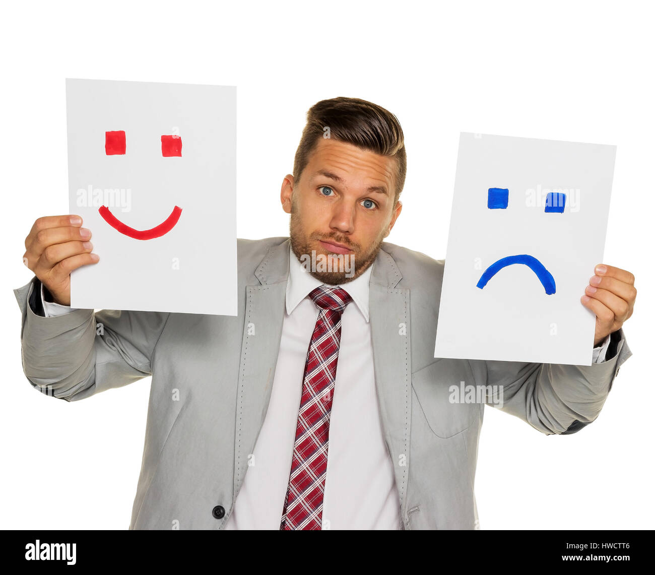 A manager or enterpriser cannot decide whether he should cry or laugh, Ein Manager oder Unternehmer kann sich nicht entscheiden ob er weinen oder lach Stock Photo